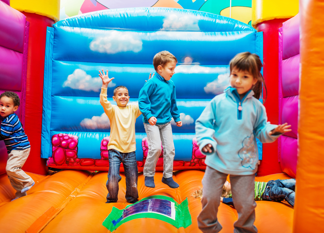 Kids enjoying in bouncy castle.